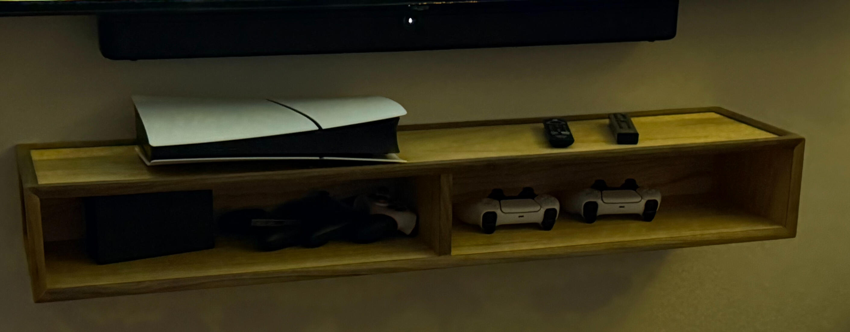 Floating shelf for gaming consoles - Oaks ply with waterfall sides and trimmed out with walnut.